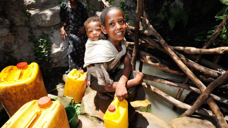 Girl with water tanks in abune ginde beret