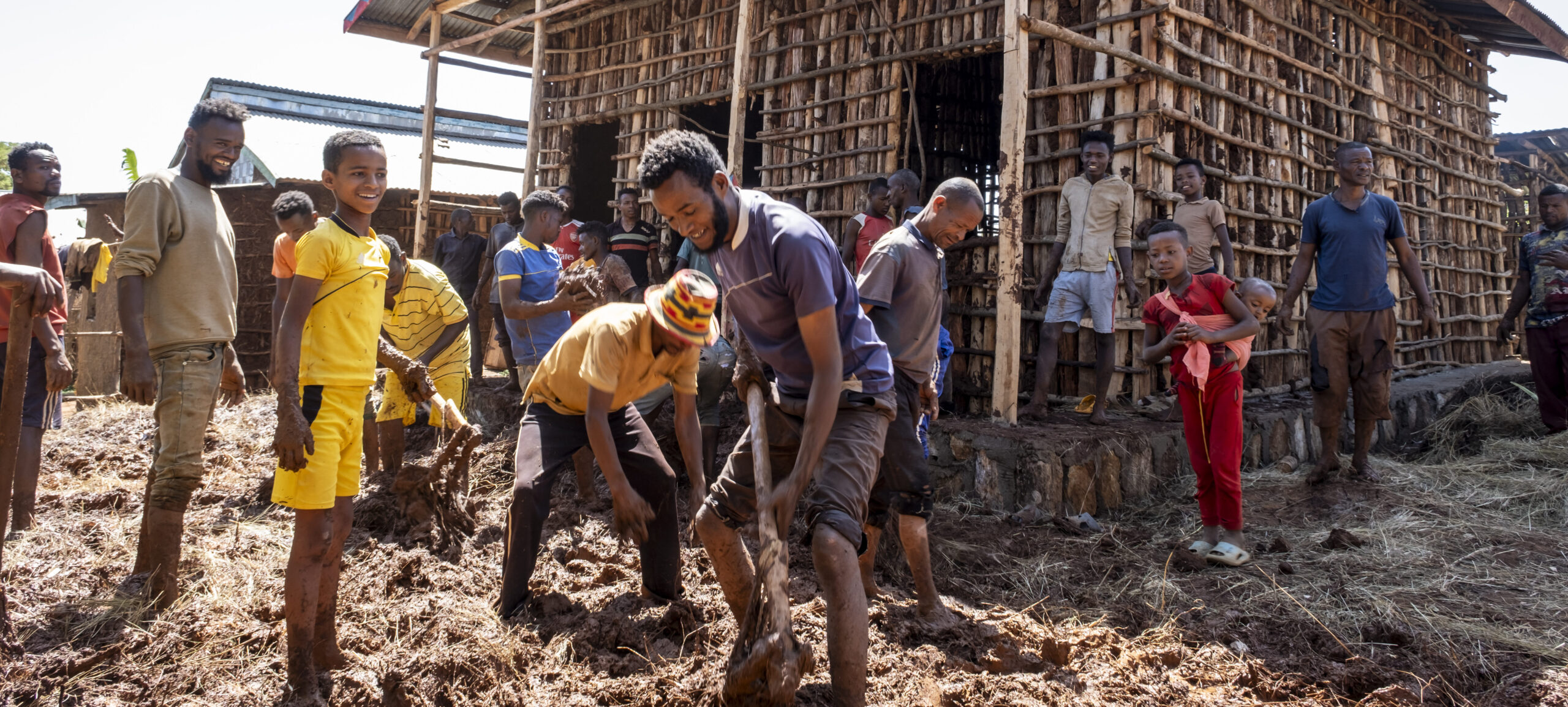 A community of neighbours is building a new house.