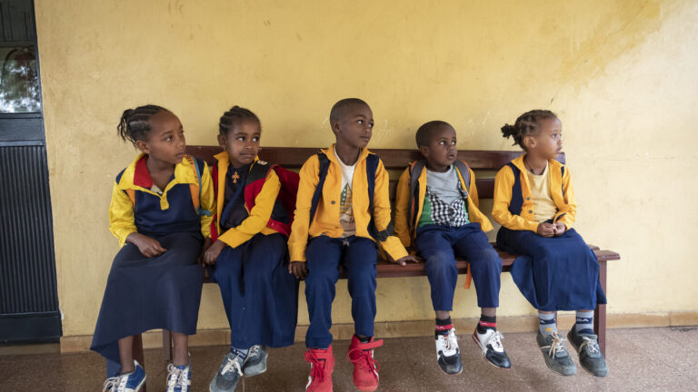 Children of Abdii-Borii on a bench