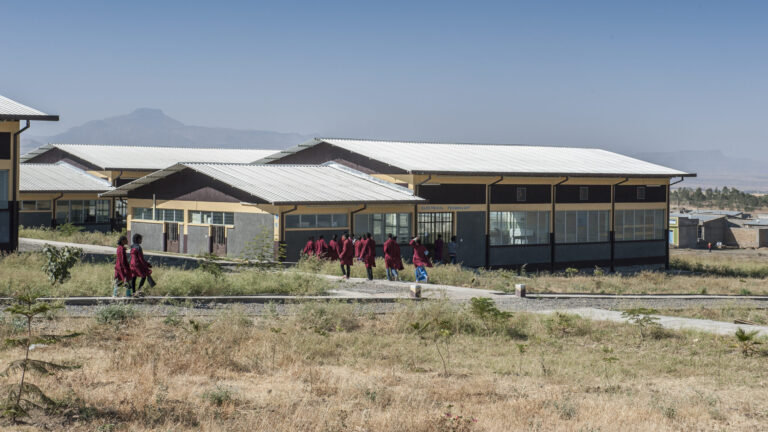 Students walk towards the buidlings of a newly built TVET training centre.