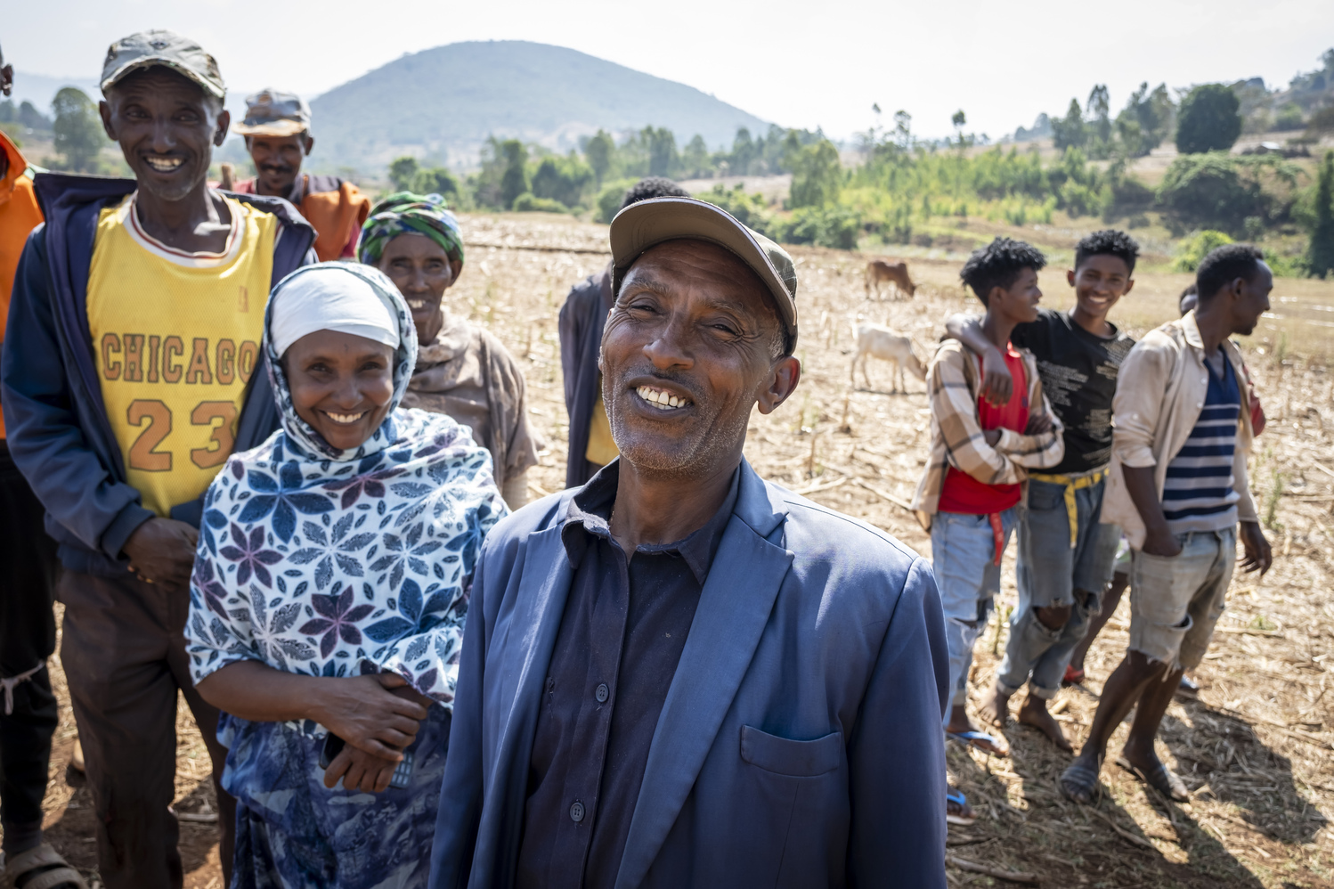 A group of people is standing outside on a field.