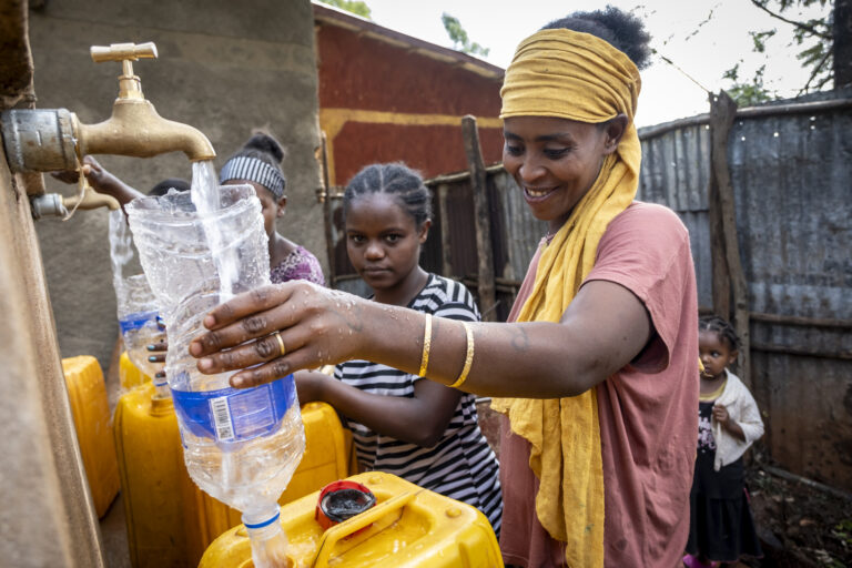 Women drawing clean water from a newly constructed well.