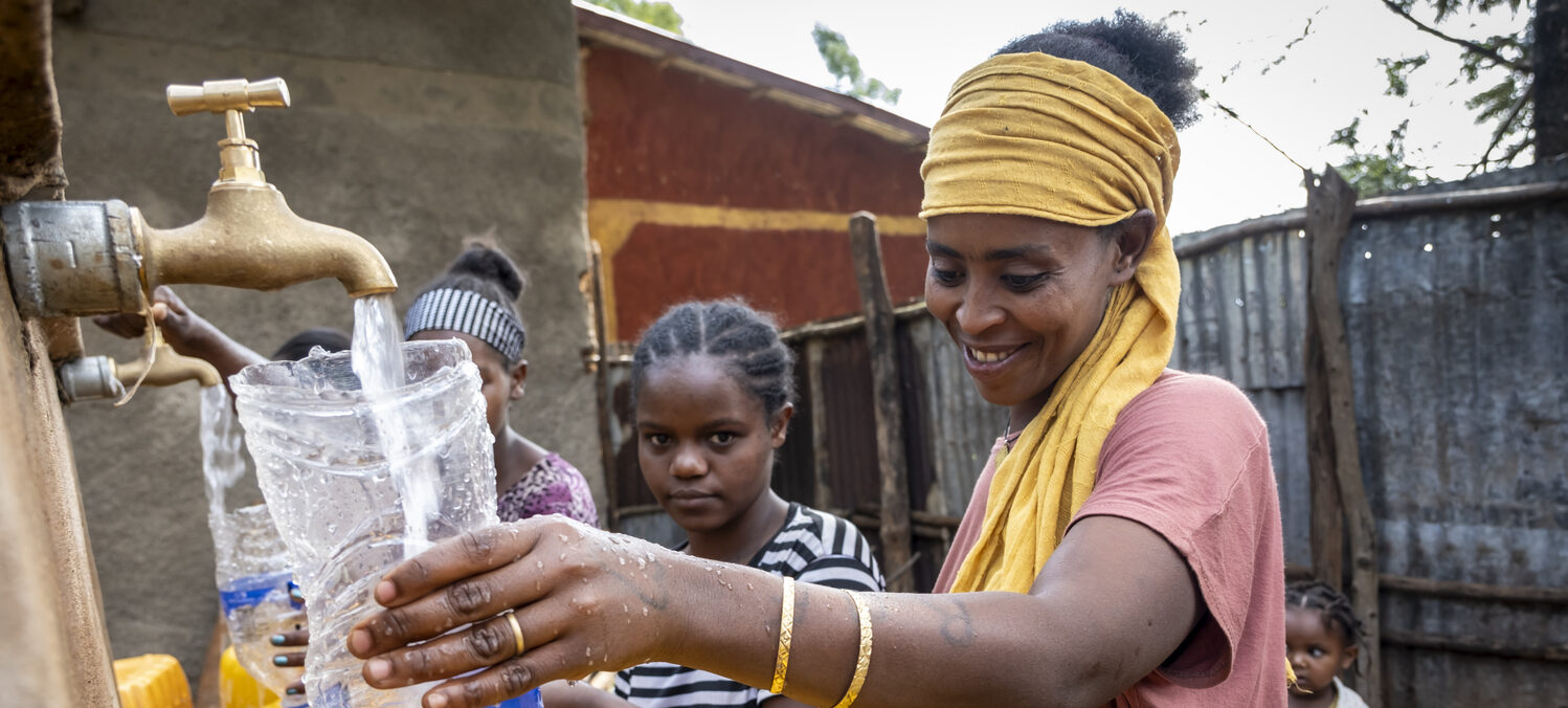 Women drawing clean water from a newly constructed well.