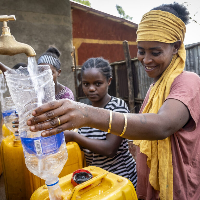Women drawing clean water from a newly constructed well.