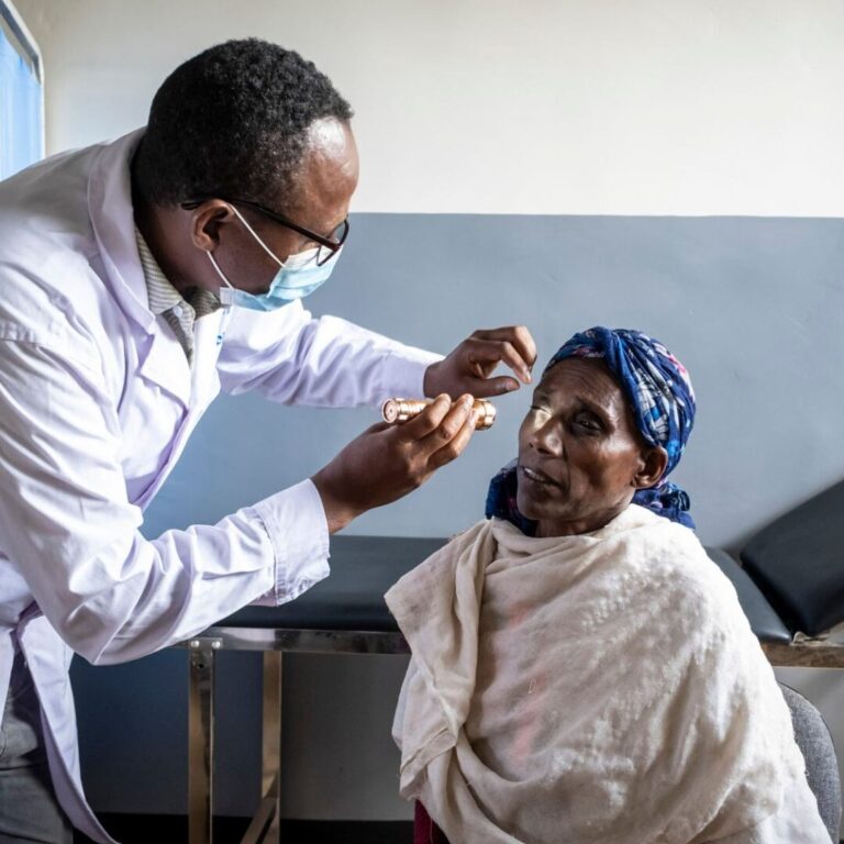 A doctor is examining a patient's eye.