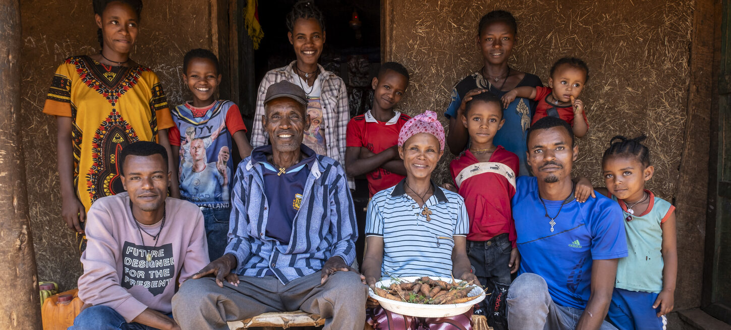 A family photo in front of their house. With the harvest.
