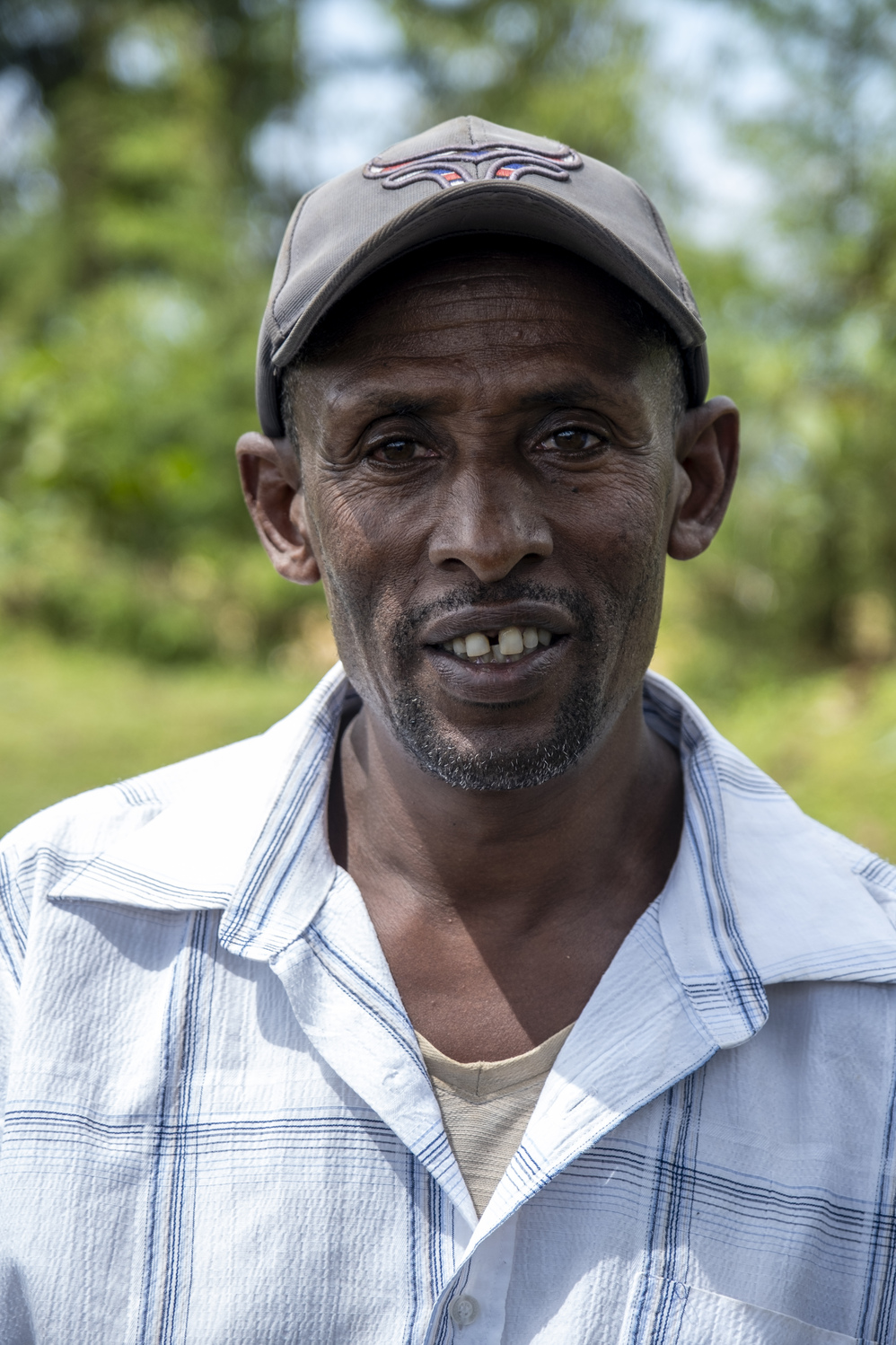Portrait of a man wearing a cap.